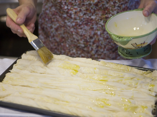 Keith Johnson  |  The Salt Lake Tribune

Munira Causevic brushes the Bosnian pita with oil before putting in the oven.