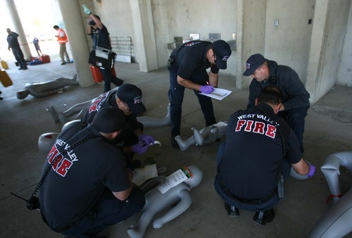 Leah Hogsten  |  The Salt Lake Tribune
Over 70 responders from Salt Lake City, Unified and West Valley City Fire Departments worked the scene. The Salt Lake City Fire Department spent the morning triaging dozens of victims from a shooting involving a single gunman at the Utah State Fairpark Wednesday, October 10, 2012.  The mock   drill was to train first responders and how they handle disasters and shooter scenarios.