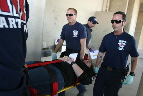 Leah Hogsten  |  The Salt Lake Tribune
 Salt Lake City Fire Department's Craig Orum (left) and Jason Davis (right) take victim Allison Tripp to the treatment area where victims are re-assessed and evacuated according to injury and health. The Salt Lake City Fire Department spent the morning triaging dozens of victims from a shooting involving a single gunman at the Utah State Fairpark Wednesday, October 10, 2012.  The mock   drill was to train first responders and how they handle disasters and shooter scenarios.