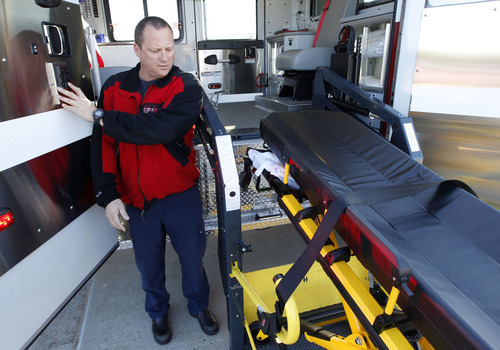 Al Hartmann  |  The Salt Lake Tribune
Capt. Mark Ownsbey lowers a stretcher on a lift system on West Valley City Fire Department's new combination fire engine/ambulance. The first-of-its-kind lift system makes it easier to put patients in the vehicle and the ambulance has more room for paramedics to work on patients.