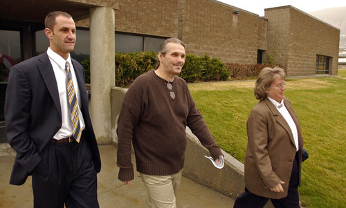 Bruce Dallas Goodman, center, is all smiles after being released from prison after serving 19 years for a rape and murder charge conviction vacated by new DNA evidence.  At his side was staff attorney Josh Bowland and Jensie Anderson, president of the Rocky Mountain Innocence Center.  Goodman who had been serving in a Gunnison prison was moved to the main prison in Draper for his release on Tuesday afternoon.     Photo by Francisco Kjolseth/The Salt Lake Tribune 11/09/2004