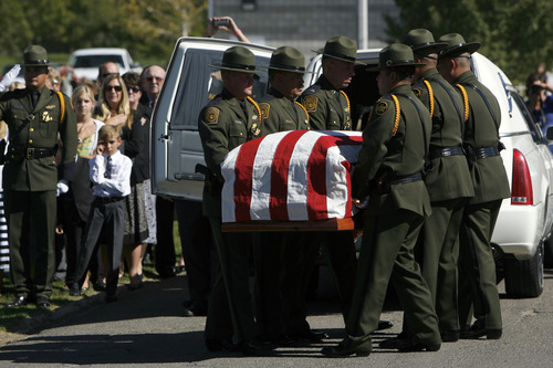 Francisco Kjolseth  |  The Salt Lake Tribune
U.S. Customs and Border Patrol agents move the casket containing border patrol agent Nicholas Ivie after arriving at the Spanish Fork Cemetery surrounded by friends, family, and numerous service agencies on Thursday, October 11, 2012.