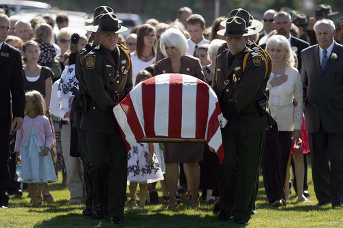 Francisco Kjolseth  |  The Salt Lake Tribune
U.S. Customs and Border Patrol agents move the casket containing border patrol agent Nicholas Ivie after arriving at the Spanish Fork Cemetery surrounded by friends, family, and numerous service agencies on Thursday, October 11, 2012.