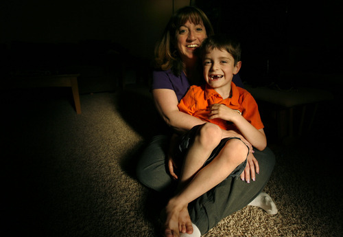 Gayle Burns holds her son Ian in their home in Murray Wednesday Jun 30, 2010. Burns' husband Michael died after cancer treatment in 2001. Before undergoing therapy, Michael stored sperm because the treatments made him sterile. After he died, Gayle conceived a son -- Ian -- who was born in 2003. She is fighting to get Ian recognized as MIchael's son so he can receive Social Security survivor's benefits. The case is at the Utah Supreme Court, and is the first case of its type in the state. The issue has also been raised in other states. Steve Griffin  |  The Salt Lake Tribune