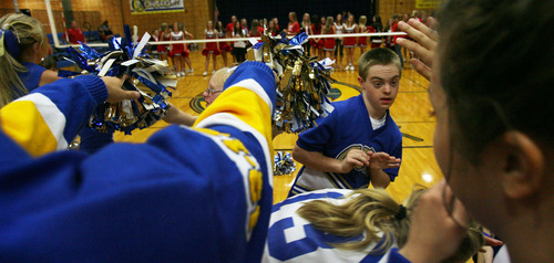 Steve Griffin | The Salt Lake Tribune


 Centerville Junior High cheerleader, Colton Beck, forms a tunnel with other cheerleaders as the school's volleyball team runs through during a game at the Centerville, Utah school Wednesday September 26, 2012.  The squad has four cheerleaders with special needs, including Colton, and the school has rallied around the kids and really supported them.