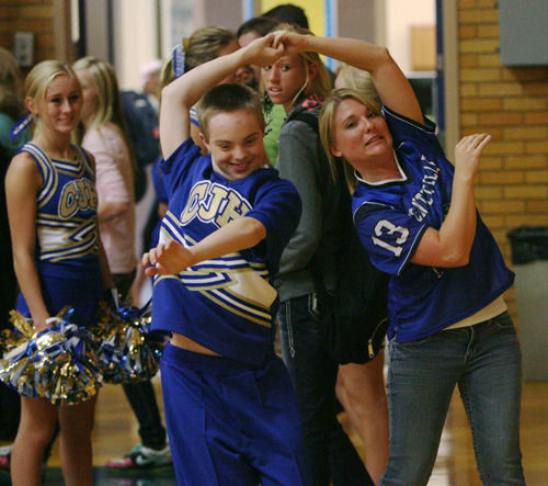 Steve Griffin | The Salt Lake Tribune


 Angie Petty, right, cheer coach for the Centerville Junior High cheerleaders, dances with Colton Beck, during a volleyball game at the Centerville, Utah school Wednesday September 26, 2012.  The squad has four cheerleaders with special needs, including Colton, and the school has rallied around the kids and really supported them in