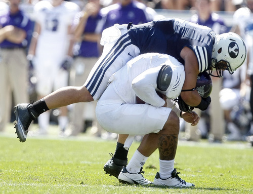 Chris Detrick  |  The Salt Lake Tribune
Weber State Wildcats quarterback Mike Hoke (11) is sacked by Brigham Young Cougars linebacker Spencer Hadley (2) during the first half of the game against Weber State at LaVell Edwards Stadium Saturday September 8, 2012. BYU is winning the game 21-0.