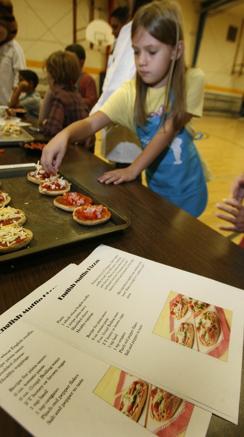 Paul Fraughton | The Salt Lake Tribune
Savannah Wendelboe, 8, makes an English muffin pizza on Oct. 1, 2012.