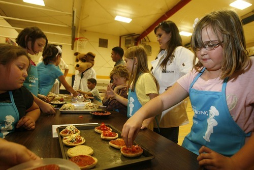 Paul Fraughton | The Salt Lake Tribune
Youngsters at the Murray Boys and Girls Club make healthy English muffin pizzas at a cooking class at the club sponsored by Molina Health Care.