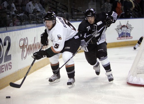 Kim Raff | The Salt Lake Tribune
(left) Utah Grizzlies player Josh Burrows tries to gain control of the puck as Idaho Steelheads player Corey Tamblyn follows during the Grizzlies' home opener at the Maverick Center in West Valley City, Utah on October 13, 2012.