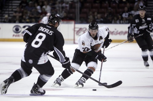 Kim Raff | The Salt Lake Tribune
(right) Utah Grizzlies player Paul McIlveen takes the puck down the ice and tries to get past Idaho Steelheads player Ben Ondrus during the Grizzlies home opener at the Maverick Center in West Valley City, Utah on October 13, 2012.