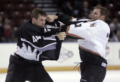 Kim Raff | The Salt Lake Tribune
(right) Utah Grizzlies player Tommy Maxwell fights with Idaho Steelheads player Scott Todd during the Grizzlies' home opener at the Maverick Center in West Valley City, Utah on October 13, 2012.