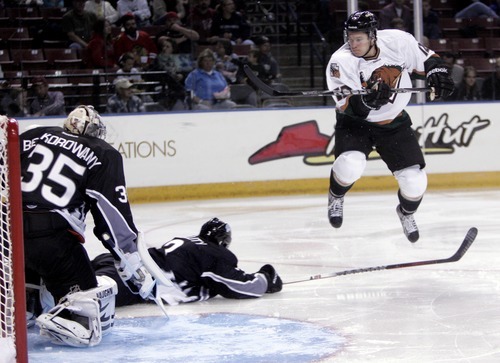 Kim Raff | The Salt Lake Tribune
Utah Grizzlies player Bryan Cameron jumps over the stick of  Idaho Steelheads player Patrick Cullity during the Grizzlies' home opener at the Maverick Center in West Valley City, Utah on October 13, 2012.