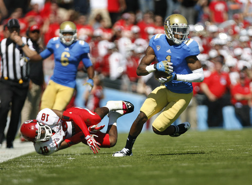 Scott Sommerdorf  |  The Salt Lake Tribune             
UCLA Bruins wide receiver Shaquelle Evans (1) evades Utah Utes defensive back Eric Rowe (18) and scores on a 64yd TD catch and run to give UCLA a 14-7 lead in the first half. Utah lost to UCLA 21-14 in Pasadena, Saturday, October 13, 2012.