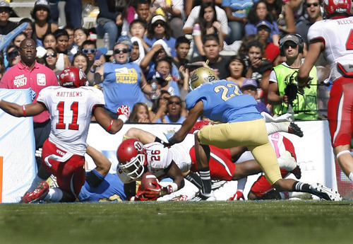Scott Sommerdorf  |  The Salt Lake Tribune             
UCLA Bruins running back Steven Manfro (33) fumbles a punt into the end zone where Utah Utes defensive back Ryan Lacy (26) recovered for the Utes first TD, tying the score at 7-7. UCLA defeated Utah 21-14 in Pasadena, Saturday, October 13, 2012.