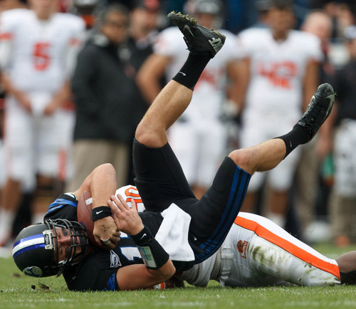 Trent Nelson  |  The Salt Lake Tribune
BYU quarterback Riley Nelson is brought down by Oregon State's Michael Doctor in a game Saturday, Oct. 13, 2012 in Provo.