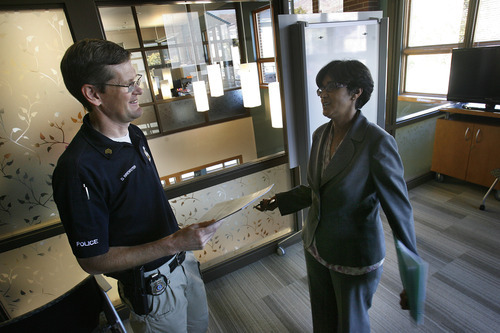 Scott Sommerdorf  |  The Salt Lake Tribune             
SLCPD Sgt. Dan Brewster speaks with Asha Parekh in one of the main counseling rooms at the YWCA center at 310 E. 300 South in Salt Lake City. The YWCA announced a new $900K grant to help pay for more police and prosecutor time to combat domestic violence, Monday, October 15, 2012.
