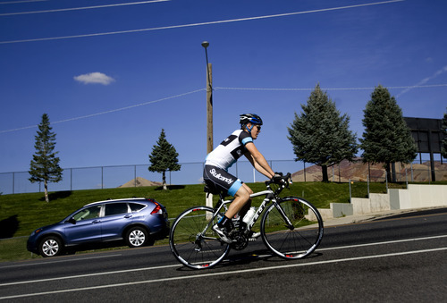 Kim Raff  |  The Salt Lake Tribune
A bike rider travels on east Sunnyside Avenue in Salt Lake City on Sunday, October 14, 2012. In January, Mayor Ralph Becker, as part of his 