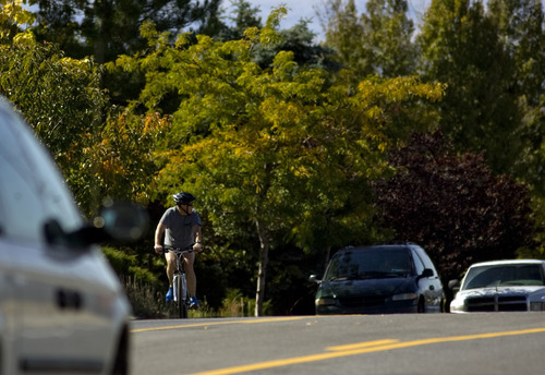 Kim Raff  |  The Salt Lake Tribune
A bike rider travels east on Sunnyside Avenue in Salt Lake City on Sunday, October 14, 2012. In January, Mayor Ralph Becker, as part of his 