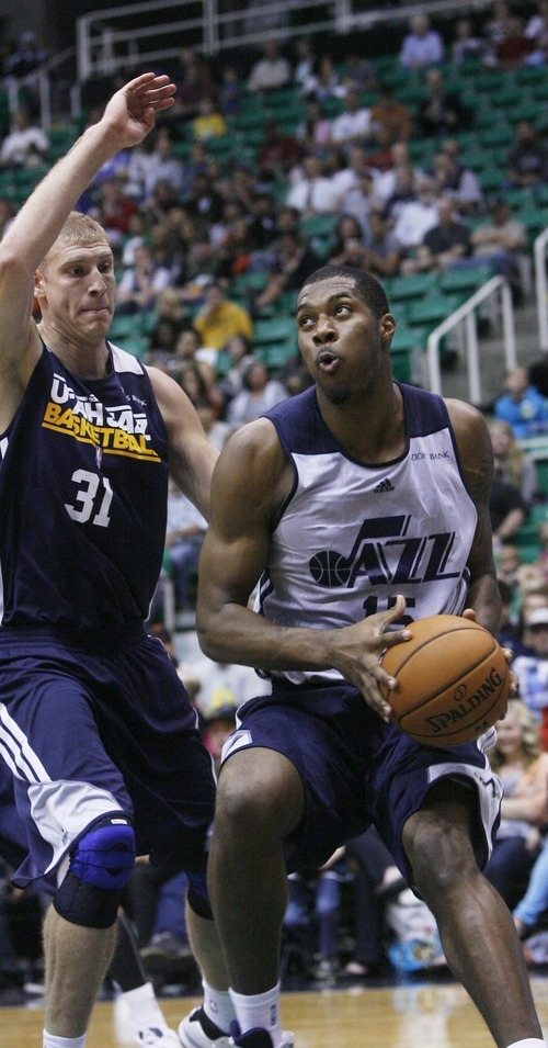 Kim Raff | The Salt Lake Tribune
Derrick Favors, right, drives the basket past Brian Butch during the Jazz Scrimmage at EnergySolutions Arena in Salt Lake City on Oct. 6, 2012.