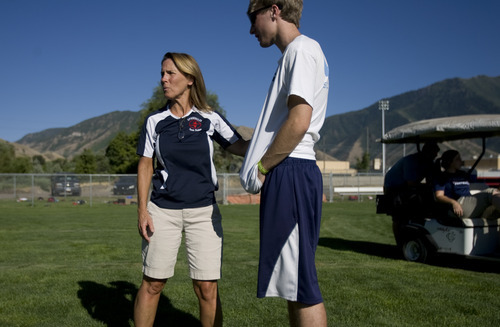 Kim Raff | The Salt Lake Tribune
Lisa Walker, the Springville High School athletic trainer, talks with Kevin Payne during Springville High School football practice in Springville in August.  Payne had recently sustained a non-football related concussion and Walker was talking to him about his sensitivity to light due to the concussion.