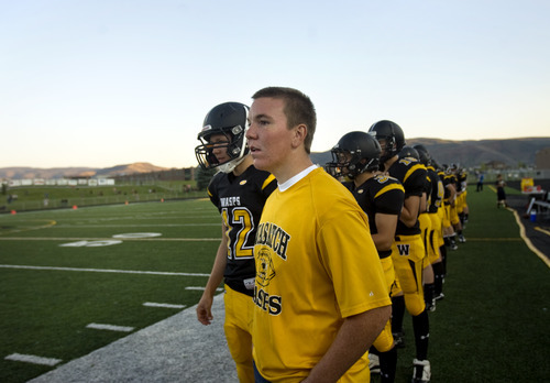 Kim Raff | The Salt Lake Tribune
Koen Hyde sustained a severe concussion during wrestling season last spring that has kept him on the sidelines this football season. Hyde stands on the sidelines and watches the Wasatch High School varsity football team play a home game against Juab in Heber on Sept. 7, 2012.