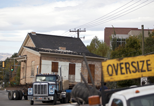 Lennie Mahler  |  The Salt Lake Tribune
A truck pulls the Casto Home, weighing about 110-tons, along Murray Holladay Road to be set in the City Hall Park about a half mile away. Saturday, Oct. 20, 2012.