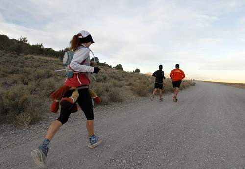 Al Hartmann  |  The Salt Lake Tribune
Competetive-elite runners run comfortably at mile 6 during the Pony Express Trail 100 Endurance Run Friday, Oct. 19. Some 75 entrants and their support teams will run the 50-mile course or the 100-mile course along the historic Pony Express route in the west desert areas of Tooele and Juab counties.