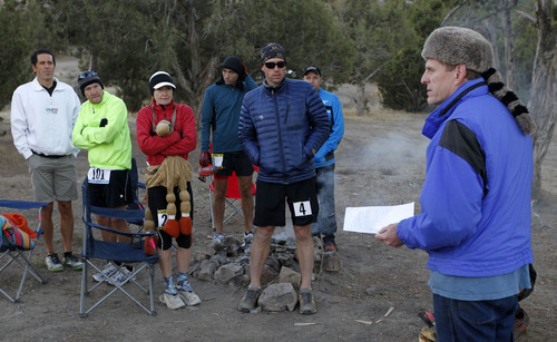 Al Hartmann  |  The Salt Lake Tribune
Race organizer Davy Crockett, right, gives last-minute instructions to the 15 runners in the competive-elite class at the start of the Pony Express Trail 100 Endurance Run Friday morning, Oct. 19.    Some 75 entrants and their support teams will run the 50-mile course or the 100-mile course along the historic Pony Express route in the west desert areas of Tooele and Juab counties.