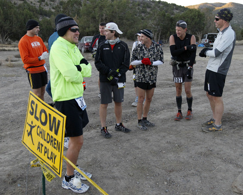 Al Hartmann  |  The Salt Lake Tribune
Fifteen runners in the competive-elite class shiver before the start of the Pony Express Trail 100 Endurance Run Friday morning, Oct. 19. Some 75 entrants and their support teams will run the 50-mile course or the 100-mile course along the historic Pony Express route in the west desert areas of Tooele and Juab counties.