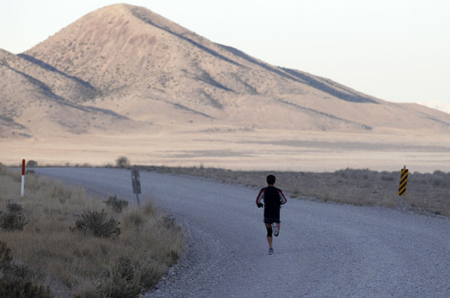 Al Hartmann  |  The Salt Lake Tribune
A runner appears of insignificant size to the surrounding mountain and valleys in the Pony Express Trail 100 Endurance Run. Some 75 entrants and their support teams will run the 50-mile course or the 100-mile course along the historic Pony Express route in the west desert areas of Tooele and Juab counties.