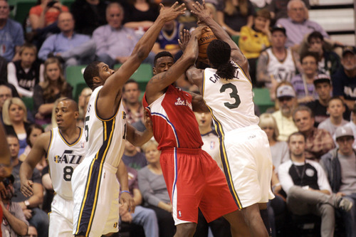 Ashley Detrick  |  The Salt Lake Tribune
Derrick Favors (15) and DeMarre Carroll (3) shut down DeAndre Jordan (6) of the Clippers in the first half of the game against the Clippers on Saturday, Oct. 20, 2012 at Energy Solutions in Salt Lake City.