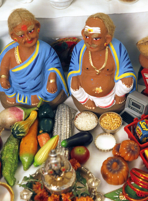Al Hartmann  |  The Salt Lake Tribune
Shopkeeper figures sit on the lowest step on Indra and Neale Neelameggham's Navratri altar.  The lowest step represents scenes from everyday life.   Hindus celebrate Navratri, a nine-day festival that is largely based in the home with friends and neighbors.
