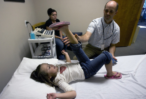 Kim Raff | The Salt Lake Tribune
Kiarah McCoy does exercises with her physical therapist Josh Brown following surgery to rebuild her hip at Rock Run Physical Therapy & Rehab Specialists in Roy, Utah on October 10, 2012. The 4-year-old's hip dysplasia might have been easily fixed had it been caught earlier by her pediatrician. The last surgery, her third, is her mother Sarah McCoy's last hope for her daughter to regain mobility. But the family, though fully insured, is struggling to pay their medical bills.