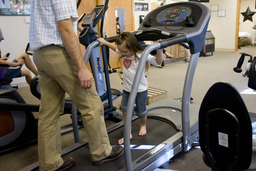 Kim Raff | The Salt Lake Tribune
Kiarah McCoy walks on a treadmill with her physical therapist Josh Brown following surgery to rebuild her hip at Rock Run Physical Therapy & Rehab Specialists in Roy, Utah on October 10, 2012. The 4-year-old's hip dysplasia might have been easily fixed had it been caught earlier by her pediatrician. The last surgery, her third, is her mother Sarah McCoy's last hope for her daughter to regain mobility. But the family, though fully insured, is struggling to pay their medical bills.