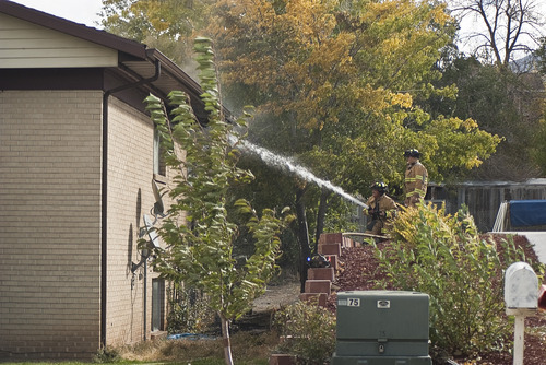 Donald W. Meyers | The Salt Lake Tribune
Payson firefighters spray water inside a burning apartment building Monday morning. Fire officials are still investigating the cause of the blaze, which spread to multiple apartments.
