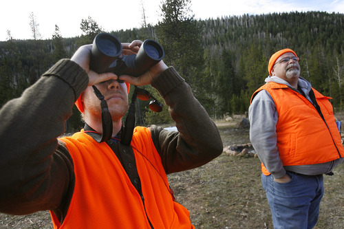 Scott Sommerdorf  |  The Salt Lake Tribune              
Nicholas Smith, left, scans the hillsides near Kamas for deer as Shawn Gehring, right, looks on, Saturday, October 20, 2012. The general season rifle deer hunt opened at dawn Saturday with a new format that limits hunters to one of 30 units instead of one of five regions in the state. More than 52,000 are expected to be in the field.
