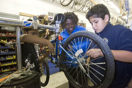 Paul Fraughton | The Salt Lake Tribune
Tony Part, Stella Langton and Bryan Cruces  work on a bike at the Bicycle collective on Thursday, Sept. 27, 2012.