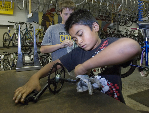 Paul Fraughton | The Salt Lake Tribune
Tony Part, 11, cleans a bike part before reinstalling it on a bike.