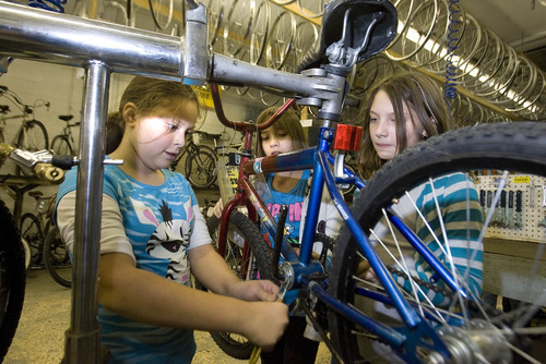 Paul Fraughton | The Salt Lake Tribune
Cianne Paul, 10, Angel Martinez, 10, and Katie Johnson team up to work on a bike at the Bicycle Collective.