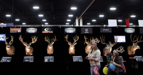 Trent Nelson  |  Tribune file photo
Antlered expo attendees walk past a display at the International Sportsmen's Exposition in March at the South Towne Exposition Center in Sandy. Officials of Salt Lake County, which owns the Exposition Center, met Tuesday with Sandy officials to coordinate what they say can be mutually beneficial development of the city's core.