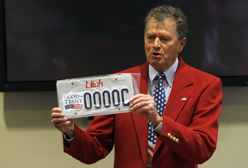 Francisco Kjolseth  |  The Salt Lake Tribune
Paul Warner, executive director of America's Freedom Festival at Provo, shows off a representation of a new license plate they hope to get the state to produce with the words 