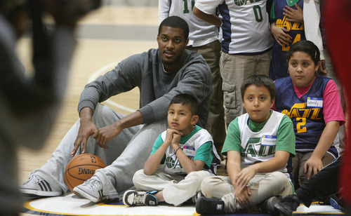 Steve Griffin | The Salt Lake Tribune

Derrick Favors sits with students from the U.S. Dream Academy as they get their pictures taken during a private basketball clinic put on by the Utah Jazz. About 55 children ages 8 to 14 attended the event at the Zions Bank Basketball Center in Salt Lake City on Wednesday, Oct. 24, 2012.
