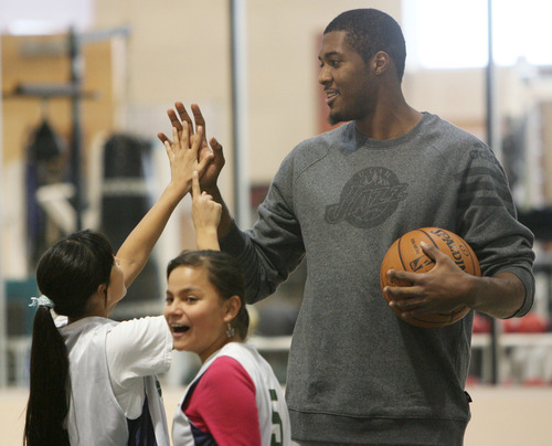 Steve Griffin | The Salt Lake Tribune

A student from the U.S. Dream Academy compares the size of her hand with Derrick Favors' hand during a private basketball clinic. About 55 children ages 8 to 14 attended the event put on by the Utah Jazz at the Zions Bank Basketball Center in Salt Lake City on Wednesday, Oct. 24, 2012.