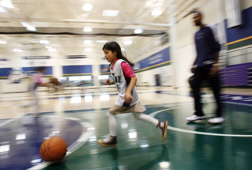 Steve Griffin | The Salt Lake Tribune

Second-grader Fatima Alfaro dribbles the ball past Mo Williams, of the Utah Jazz, as students from the U.S. Dream Academy participate in a private basketball clinic for at-risk youth. About 55 children ages 8 to 14 attended the event at the Zions Bank Basketball Center in Salt Lake City on Wednesday, Oct. 24, 2012.