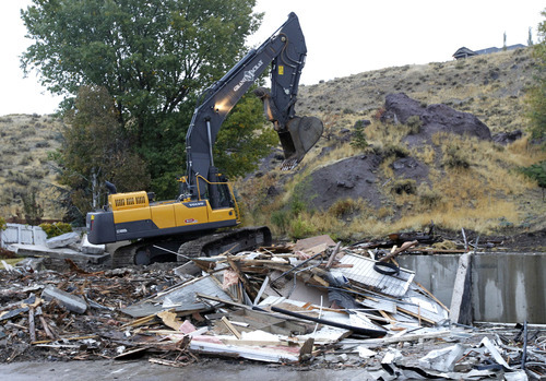 Al Hartmann  |  The Salt Lake Tribune
Backhoe finishes knocking down a house on Springhill Drive in North Salt Lake Tuesday October 23.  With the help of a federal grant North Salt Lake is stabilizing the Springhill landslide by demolishing homes in the area, shoring up others and and turning the site into an open-space park.