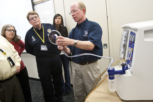 Chris Detrick  |  The Salt Lake Tribune
Microbial-Vac Systems VP of Engineering and Operations Wayne Carlsen demonstrates how to use the M-Vac System at the West Jordan Police Department Wednesday October 24, 2012.