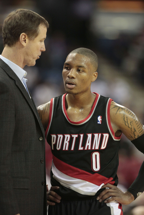 Portland Trail Blazers head coach Terry Stotts talks with rookie guard Damian Lillard during the third quarter against the Sacramento Kings in a NBA preseason basketball game in Sacramento, Calif, Monday, Oct. 15, 2012.  The Kings won 117-100.(AP Photo/Rich Pedroncelli)