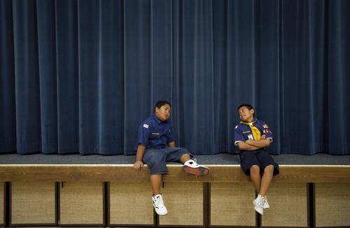 Mike Terry | Special to the Tribune

Cub Scouts Dylan Leatutufu and Desmond Tautaiolefue from Pack 4183 of the Volta Samoan Ward sit on the stage after running laps in the gym  at a meetinghouse of The Church of Jesus Christ of Latter-day Saints in West Valley City, Utah on Thursday, Oct. 11, 2012.  The Scouts were learning how to make quick meals from simple grocery items.