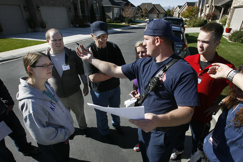 Scott Sommerdorf  |  The Salt Lake Tribune              
Firefighter Richard Berry discusses the areas to be searched by volunteers prior to them going out to search neighborhoods north of 4500 South near 1500 East for missing 80 year old Fritz Helland, Sunday, October 28, 2012.